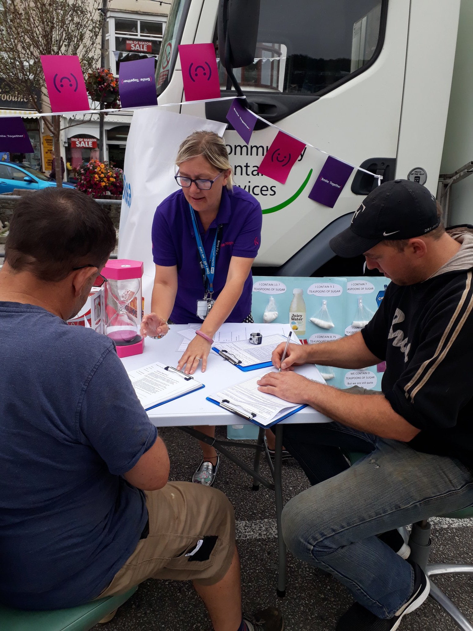 Smiles at Sea lead dental nurse Debbie helping fishermen to fill out forms during Smiles at Sea 2019