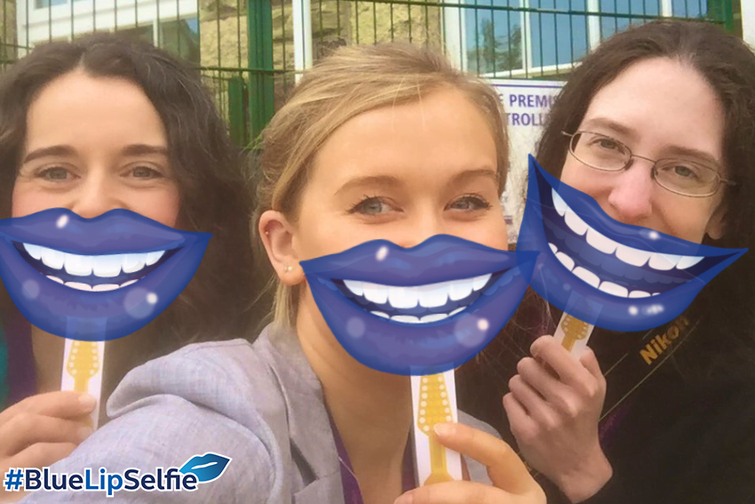 Three Smile Together team members with blue cartoon lips for Mouth Cancer Action Month blue lip selfie