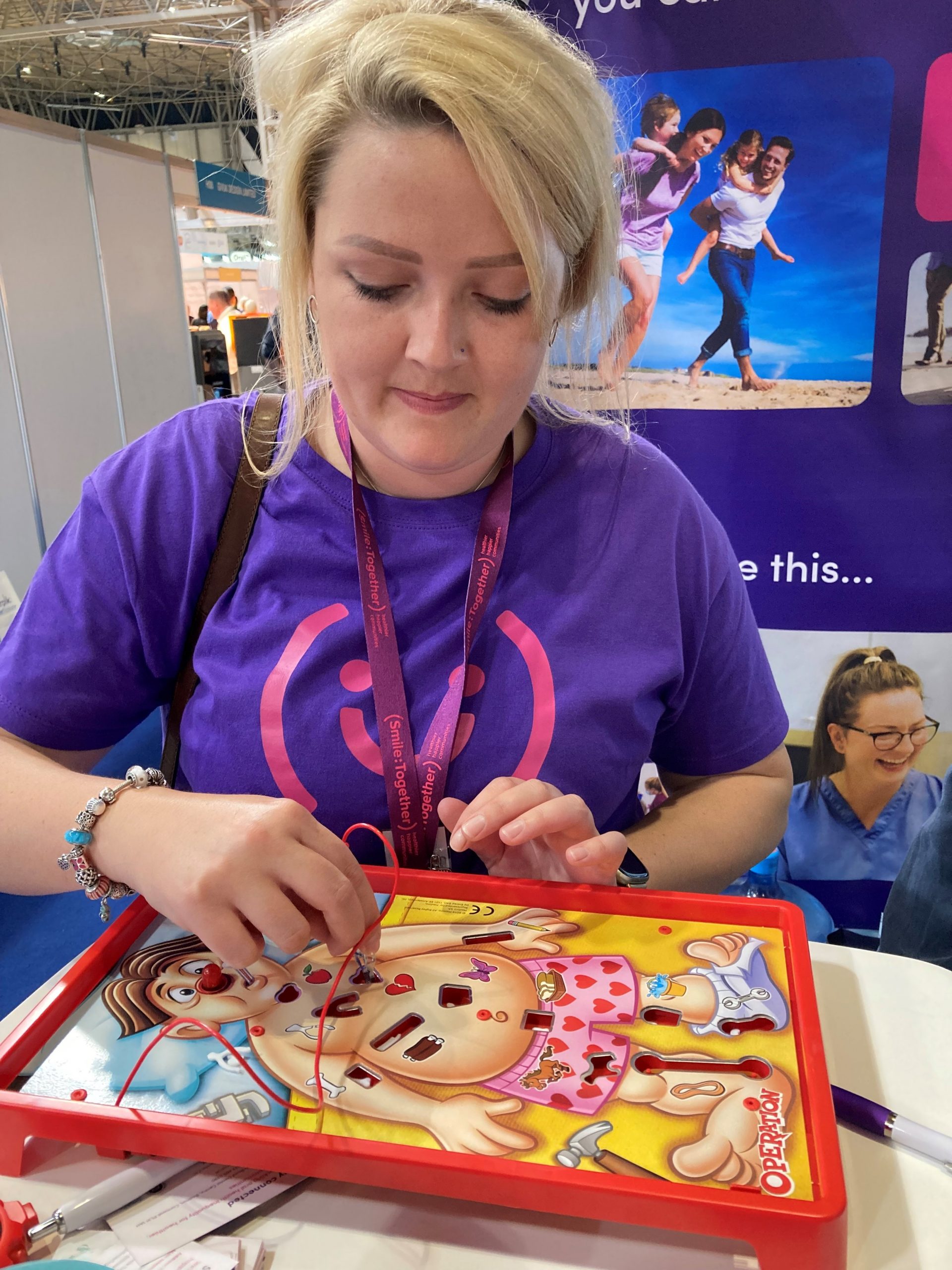 Woman playing the children's game Operation